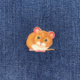 Embroidered mouse patch on a denim background