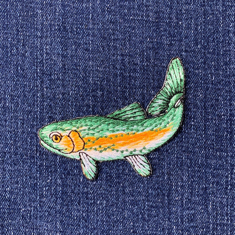 Fish-shaped patch on a blue denim background