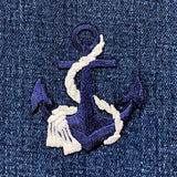 Embroidered anchor patch on denim fabric