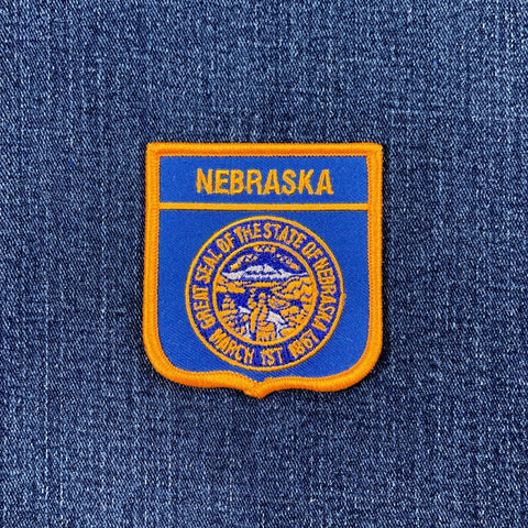 Nebraska state seal patch on a blue denim background