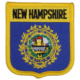 A shield-shaped embroidered patch with the text 'NEW HAMPSHIRE' at the top and an emblem in the center, bordered by a gold trim.