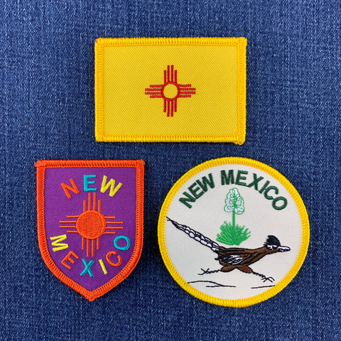 Three New Mexico-themed patches on a blue fabric background