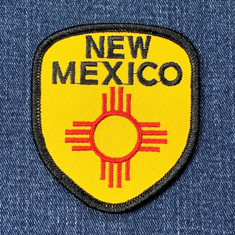 New Mexico patch with red sun design on yellow background