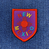 Embroidered patch with 'New Mexico' text on a denim background