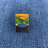 Pin with New River Gorge National Park design on a blue denim background