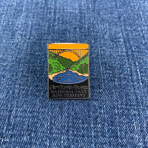 Pin with New River Gorge National Park design on a blue denim background