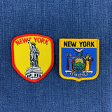two new york patches displayed on a denim background