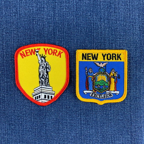 two new york patches displayed on a denim background