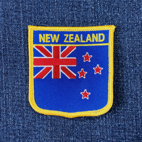 Embroidered patch with New Zealand flag design on a denim background