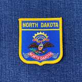 North Dakota patch on a blue denim background