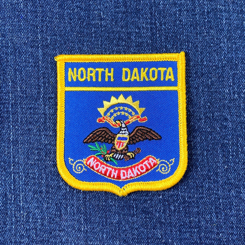 North Dakota patch on a blue denim background
