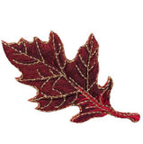 Embroidered burgundy oak leaf patch on a white background