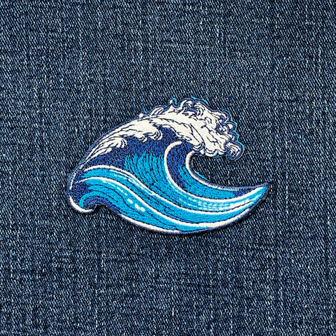 Blue wave patch on a denim background