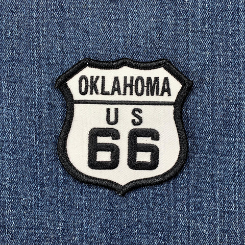 Oklahoma route 66 patch shaped like a highway sign and displayed on a denim background