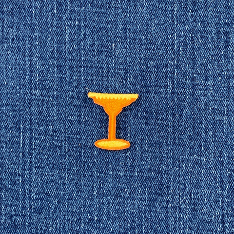 Orange cocktail glass patch on blue denim fabric
