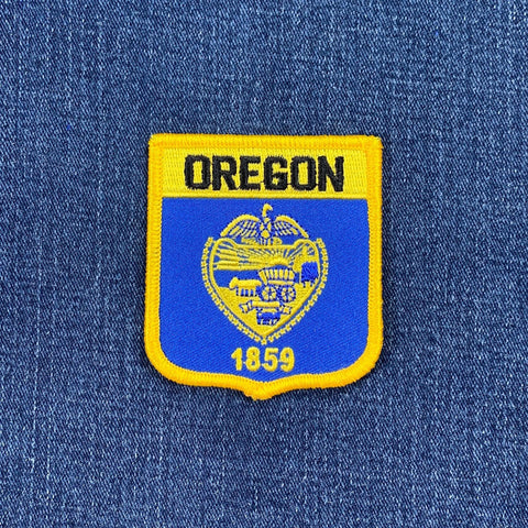 Oregon state patch with 'OREGON' and '1859' text on a blue background