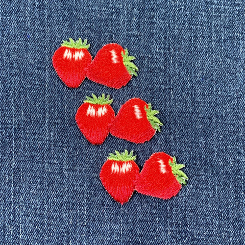 3 Red strawberry patches on denim fabric