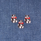 Three embroidered panda patches with red scarves on a denim background