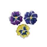 Three embroidered pansy flower patches on a white background