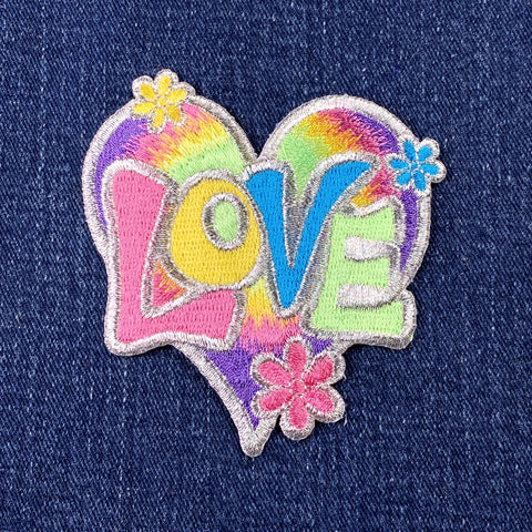 Colorful 'LOVE' patch with flowers on a denim background