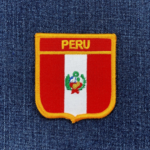 Embroidered patch of Peru's coat of arms on denim fabric