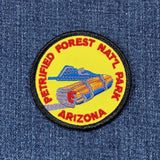 Embroidered patch of Petrified Forest National Park, Arizona on denim fabric.