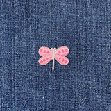 Pink dragonfly patch on blue denim fabric