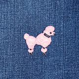 Pink poodle patch on a denim background