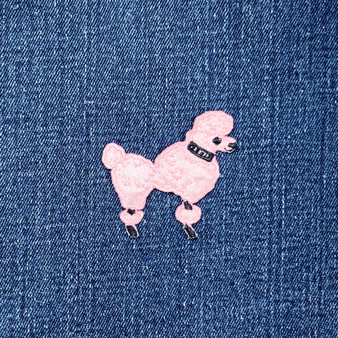 Pink poodle patch on a denim background