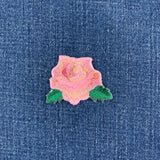 Pink rose patch on a denim background
