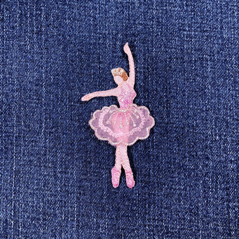 Pink ballerina patch on a denim background