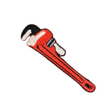 Red pipe wrench patch on a white background, designed for use with a plumber's uniform