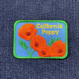 Embroidered patch of California poppies on denim fabric