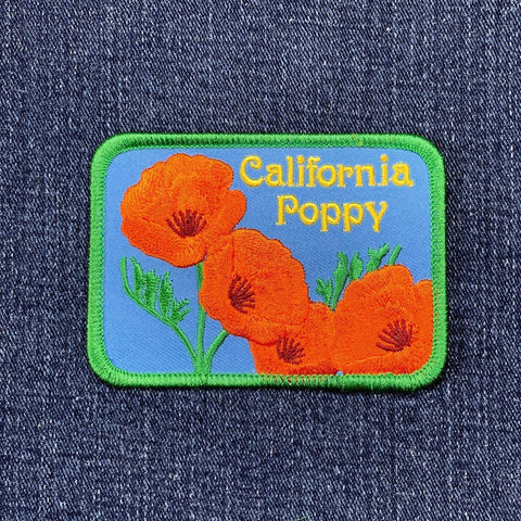 Embroidered patch of California poppies on denim fabric