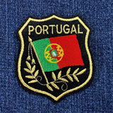 Embroidered patch of Portugal's flag on a blue denim background