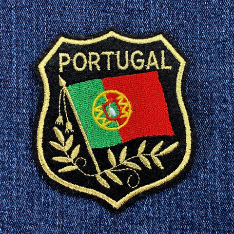 Embroidered patch of Portugal's flag on a blue denim background