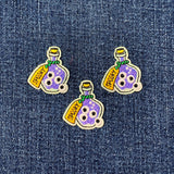 Three potion bottle patches with 'SPOOKY' text on a denim background