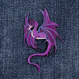 Purple dragon patch on denim fabric