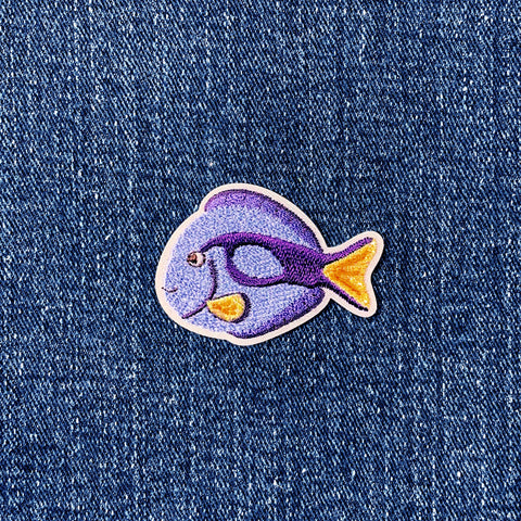 Embroidered fish patch on denim fabric