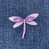 Purple dragonfly patch on denim fabric