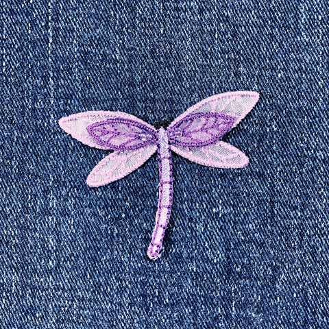Purple dragonfly patch on denim fabric