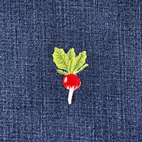 Embroidered radish patch on denim fabric