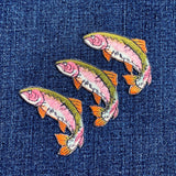 Three fish-shaped patches on a denim background