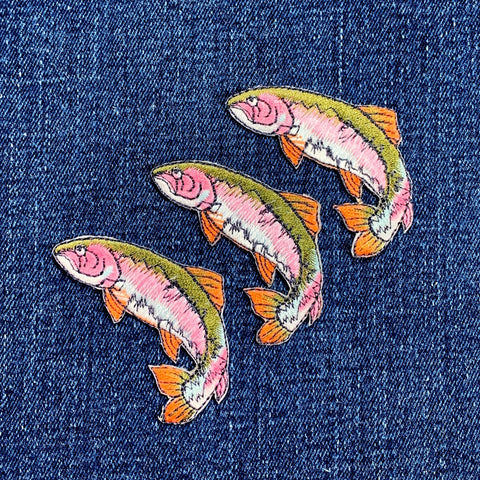 Three fish-shaped patches on a denim background