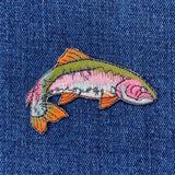 rainbow trout fish patch on a blue denim background