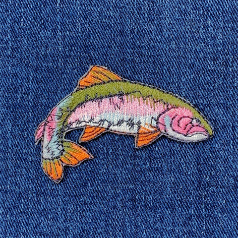 rainbow trout fish patch on a blue denim background