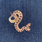 Snake-shaped patch on denim fabric