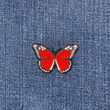 Red butterfly patch on blue denim fabric