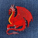 Red dragon embroidered patch on denim fabric