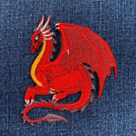 Red dragon embroidered patch on denim fabric